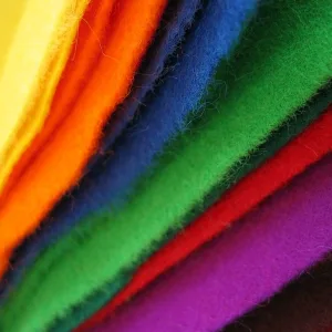 A fan of brightly dyed felt sheets in yellow, orange, blue, green, red and purple