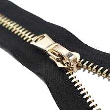 A metal zipper with gold-coloured brass teeth and slider on black tape