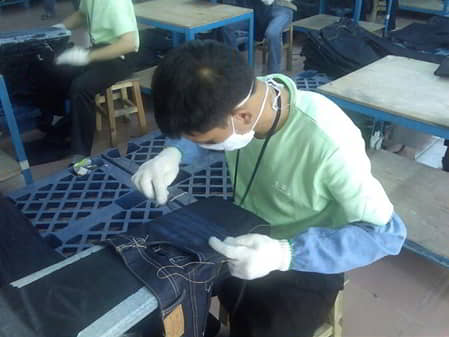 Figure 1.13 Sanding of denim jeans.