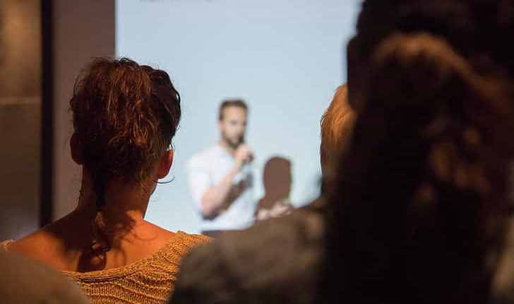 A professional presenting at a conference, engaging the crowd