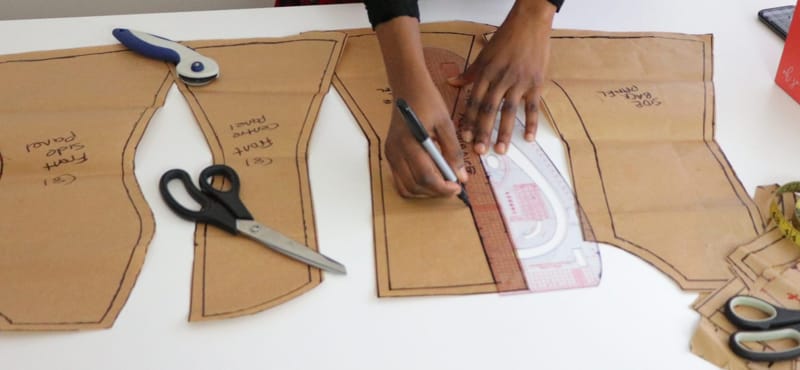 pattern maker drafting on a light table