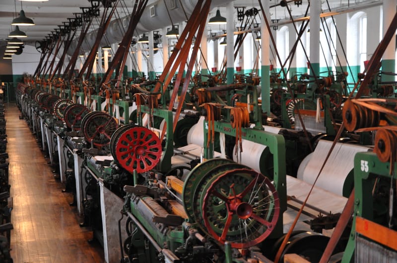 vintage textile factory scene with early power looms