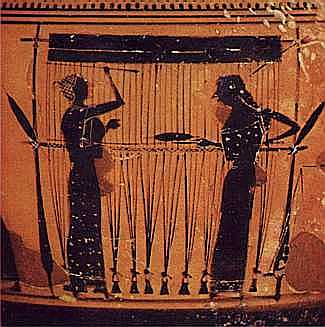 Two women at a loom, passing their shuttle back and forth